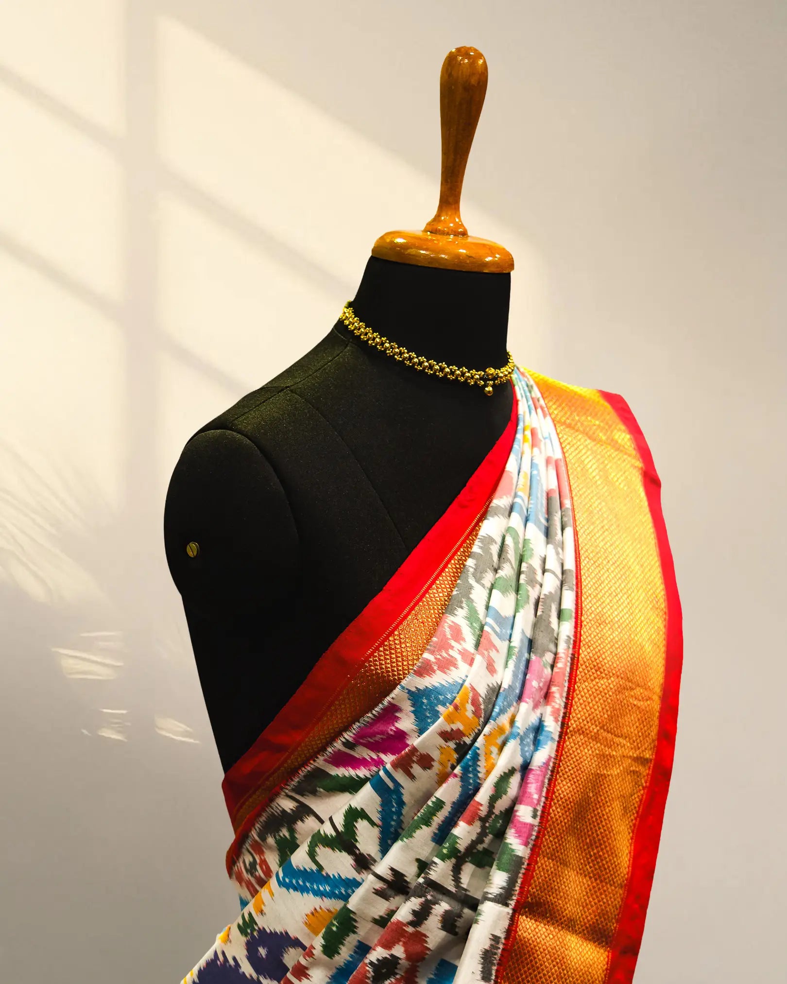 white and Golder Patola Saree
