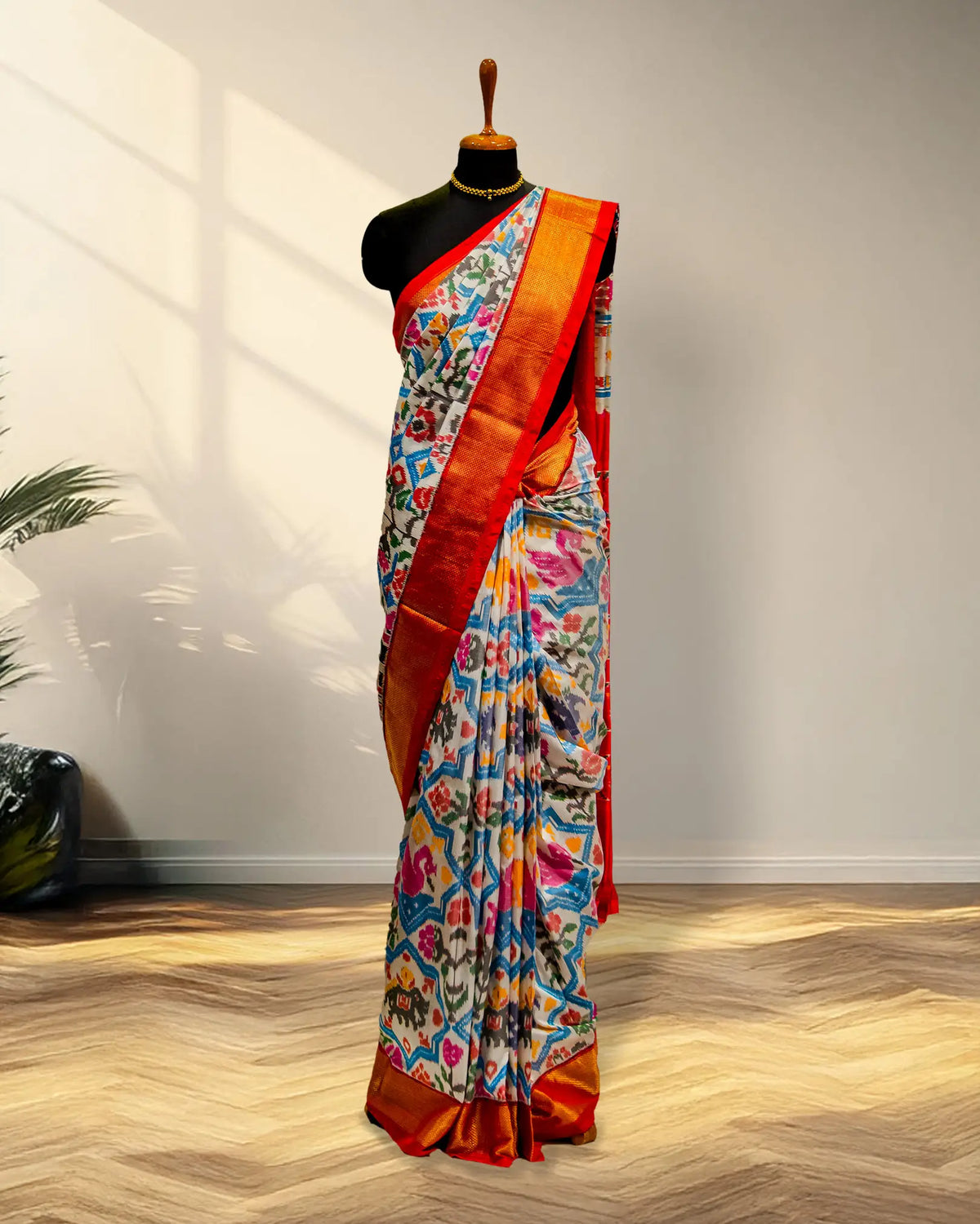 white and Golder Patola Saree